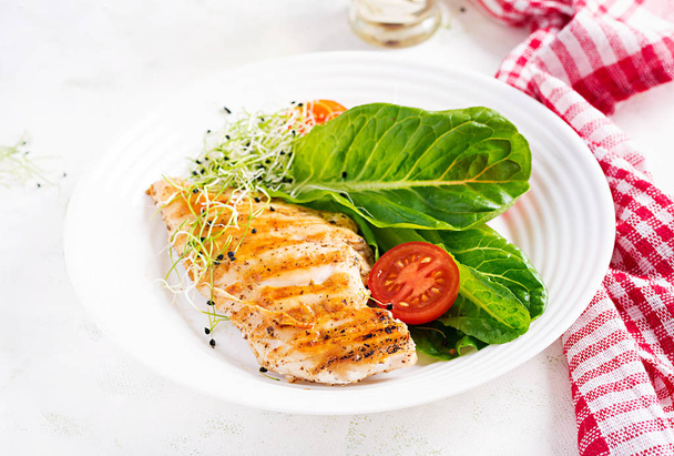 Chicken grilled fillet with salad fresh tomatoes and avocado. Healthy food, ketogenic diet, diet lunch concept. Keto/Paleo diet menu. - Photo, Image