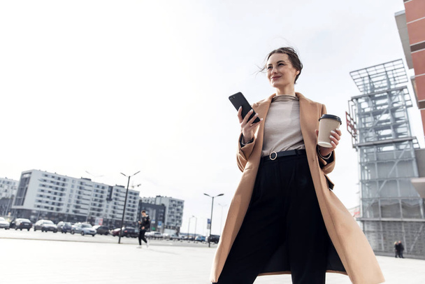 Young Businesswoman Smiling While Using a Mobile Phone - Foto, imagen