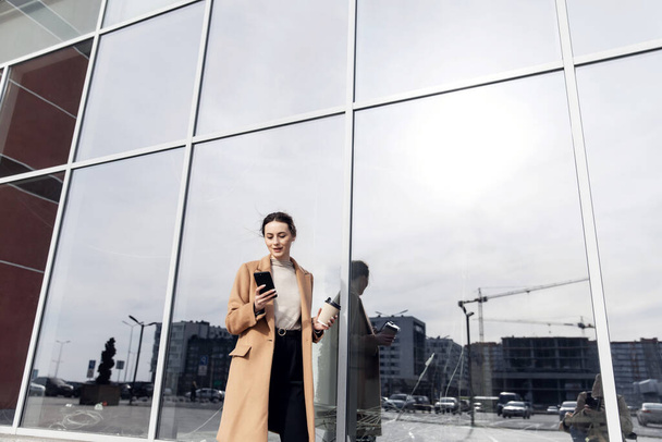 Young Businesswoman Smiling While Using a Mobile Phone - Foto, Imagem