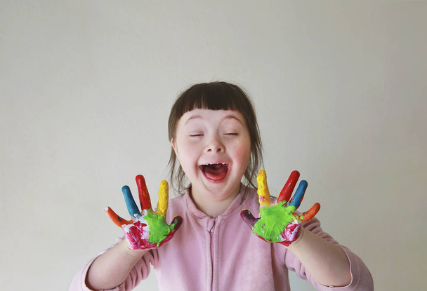 Cute little girl with painted hands. Isolated on grey background. - Photo, Image