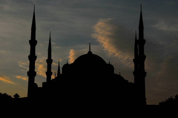 Silhouette of the Sultan Ahmed Mosque (Blue Mosque) on of most popular tourist attractions in Istanbul - Photo, Image