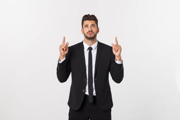 Business Concept: Portrait handsome young businessman point finger on side to empty copy space. Isolated over white background - Photo, Image