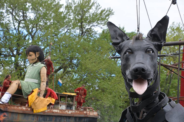 MONTREAL QUEBEC CANADA 19 05 17: Giants Xolo dog and the little giant girl walking in the street of Montreal for the 375e anniversary of the city, by Royal De Luxe company Nantes France - Zdjęcie, obraz