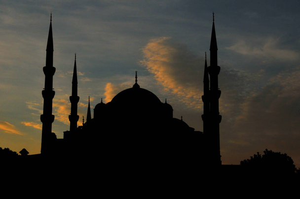 Silhouette of the Sultan Ahmed Mosque (Blue Mosque) on of most popular tourist attractions in Istanbul - Photo, Image