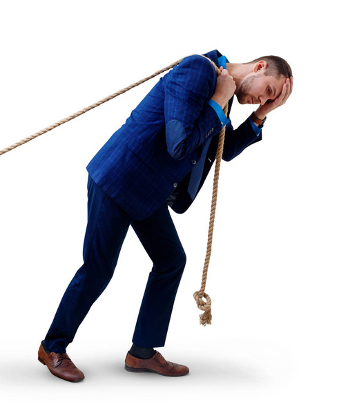 Young tired businessman pulls a rope. - Photo, Image