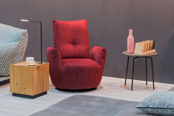 Red armchair wooden table with lamp, small coffee table in the interior. - Foto, Bild