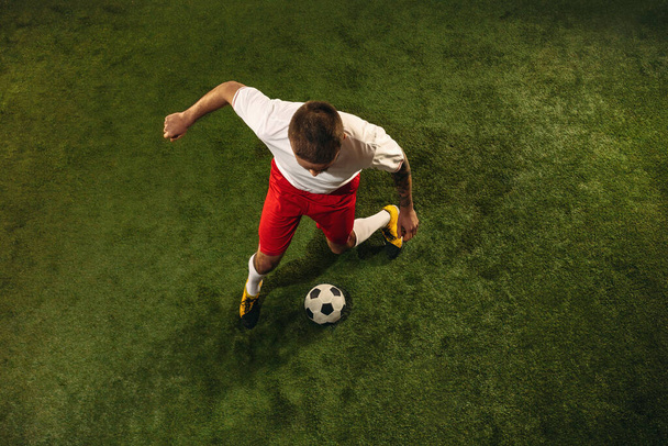 Widok z góry na piłkę nożną kaukaską lub piłkarza na zielonym tle trawy - Zdjęcie, obraz