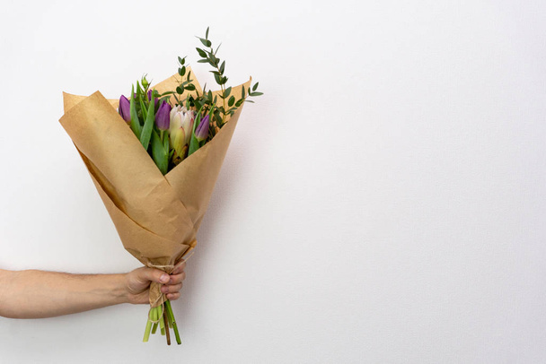 Bouquet of flowers at mans hand - Photo, image