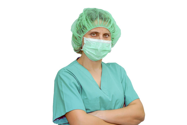 Portrait of surgeon or doctor in a mask and hat looks at the camera isolated on a white background. Image of a trainee doctor looking at the camera. - Фото, зображення