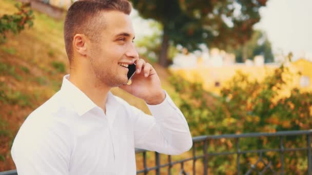 Successful, confident business man is on the phone, isolated, street background. Close up. Copy space. 4K. - Imágenes, Vídeo