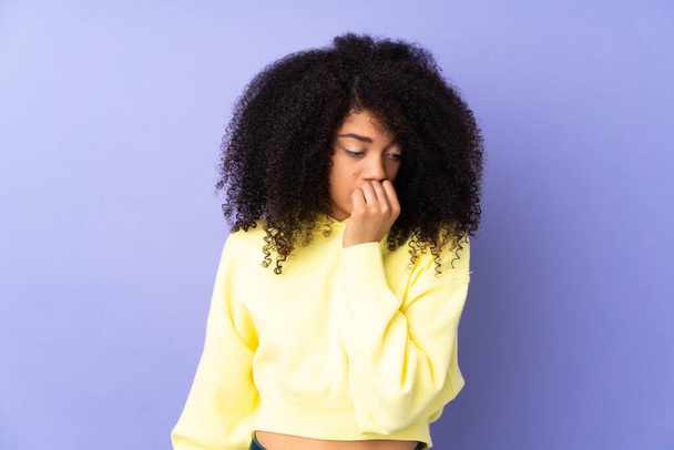 Joven mujer afroamericana aislada sobre fondo púrpura teniendo dudas - Foto, Imagen