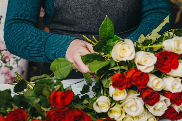 Florist at work makes a fashionable modern bouquet of different flowers - Photo, Image