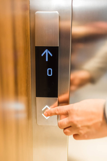 Man forefinger pressing up or down elevator button. Business success or failure concept. - Fotografie, Obrázek