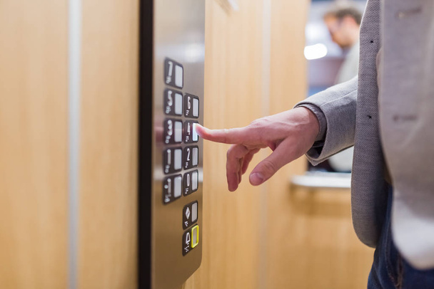 Forefinger pressing fourth floor button in the elevator. - Foto, immagini