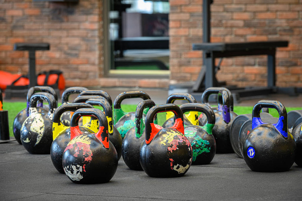 colored kettle bells in gym - 写真・画像