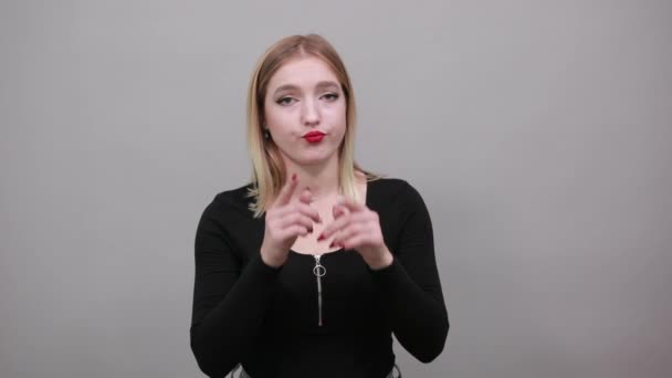 insincere woman shows a fake smile, pulls the skates of lips with index fingers - Záběry, video