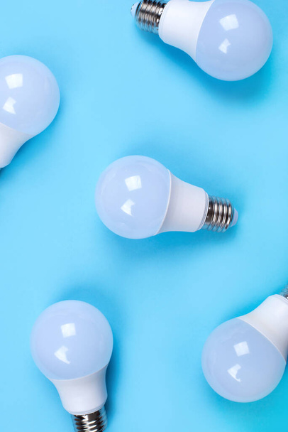Several LED bulb on blue background. Saving energy concept. - Foto, afbeelding