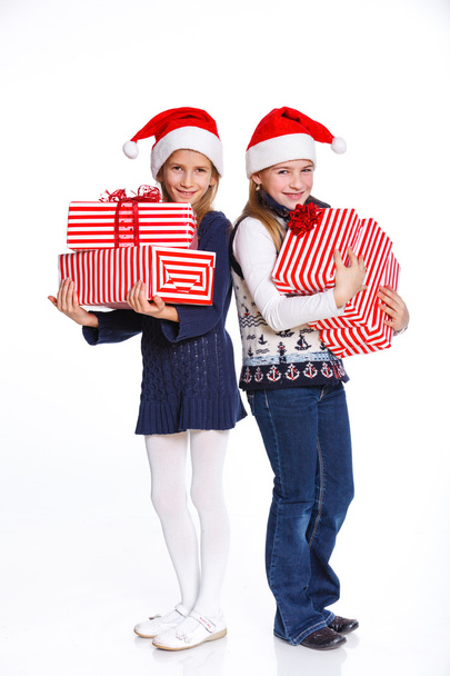 Two girl in Santa's hat with gift box - Foto, Bild