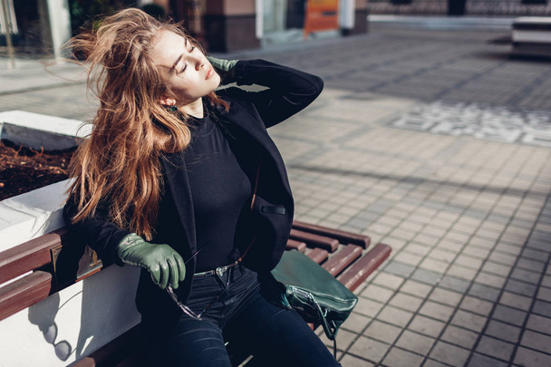 Stylish woman wearing jacket green gloves handbag outdoors on street. Spring clothes, accessories. Female trendy fashion. - Fotoğraf, Görsel