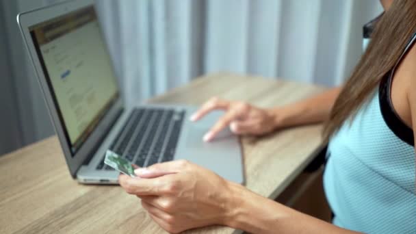 Shopping online concept. Woman hands holding credit card and using laptop - Video
