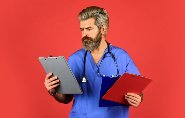 Medical nurse hold folder. pediatric healthcare. hospital or clinic. profession medicine staff. physician doctor with stethoscope and clipboard. therapist writing prescription - Photo, image