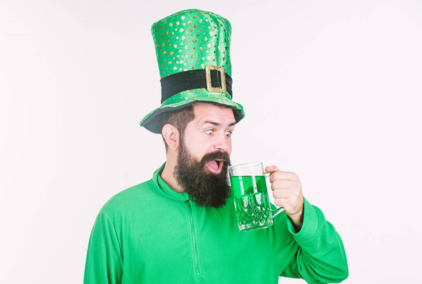 Global celebration irish culture. Man bearded hipster hat patricks day drink pint beer. Saint patricks day holiday. Colored beverage patricks holiday. Green color part of celebration. Irish beer pub - Photo, image