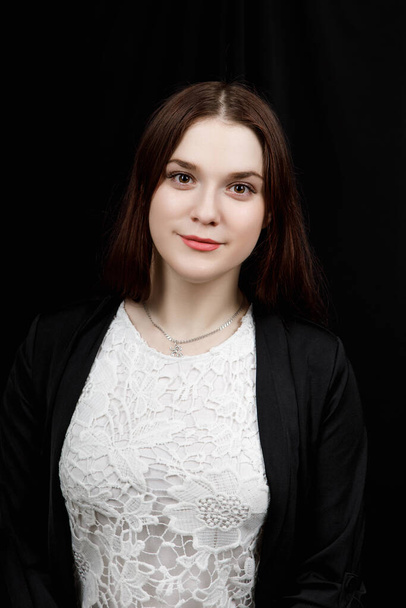 Portrait of young business woman in  a black jacket on black background - Φωτογραφία, εικόνα