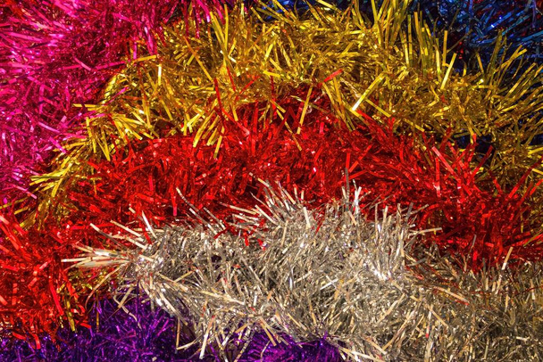 Festive, New Year background. Brilliant tinsel of different colors. Decoration for the house, festive accessory. - Photo, Image