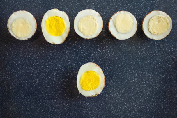 Different halves of hard-boiled eggs. The choice is unique among many. The alternative, finding your own half, is the only suitable option. View from above. - Photo, Image