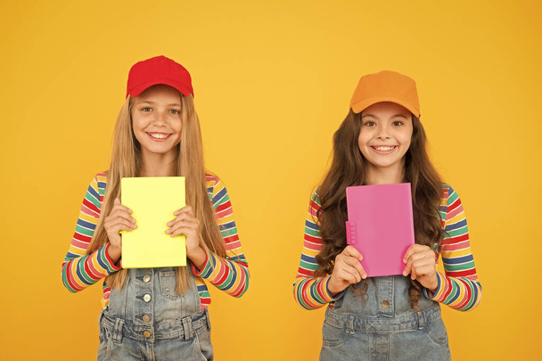 Study group can help solidify and clarify material. Kids girls with books study together. Back to school. Learning foreign languages. Effective study groups help students learn material deeper - Фото, изображение
