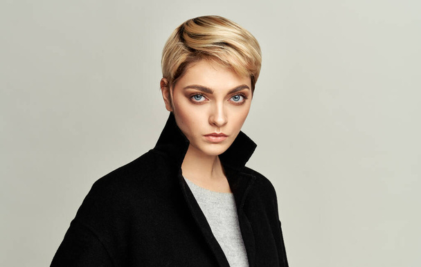 Portrait of sexy woman in blonde short hair isolated on gray background - Zdjęcie, obraz