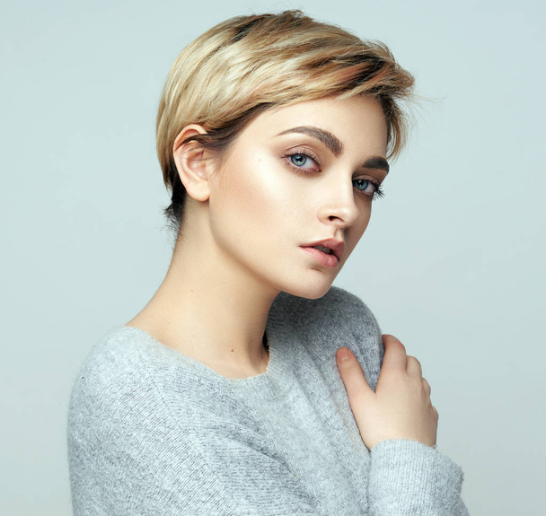 Portrait of sexy young woman with short hair isolated on gray background - Фото, изображение