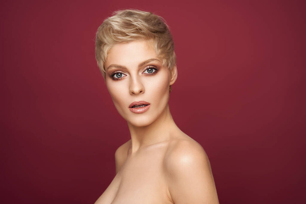 Bautiful sexy blonde woman with short hair isolated on pastel pink background  - Фото, изображение