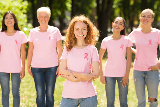 Rintasyöpä Vapaaehtoinen seisoo ryhmä naisia puistossa
 - Valokuva, kuva