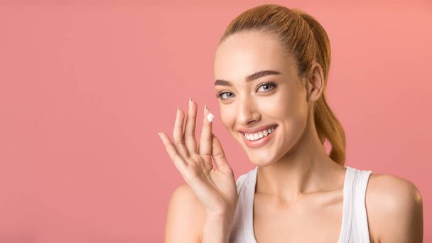 Happy Woman Applying Facial Cream Standing On Pink Background, Panorama - Fotó, kép