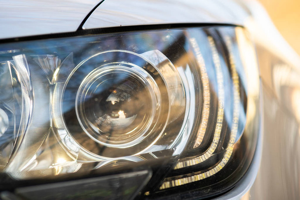 Close up view of modern car headlight with shiny optics. - Foto, Imagen