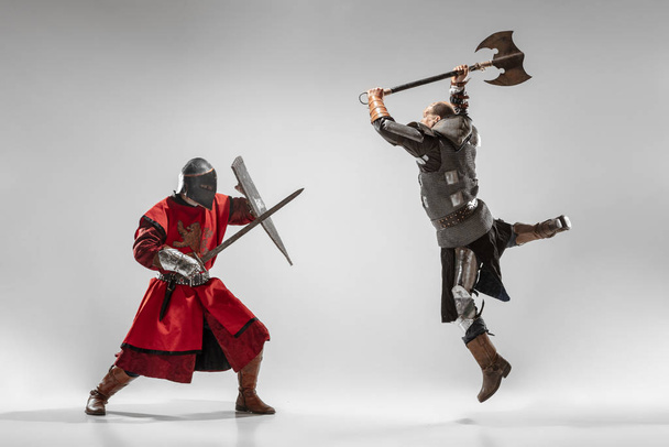 Brave armored knights fighting isolated on white studio background - Valokuva, kuva