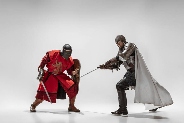 Brave armored knights fighting isolated on white studio background - Zdjęcie, obraz