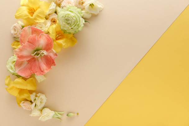 top view of spring floral bouquet on beige and yellow background - Photo, Image