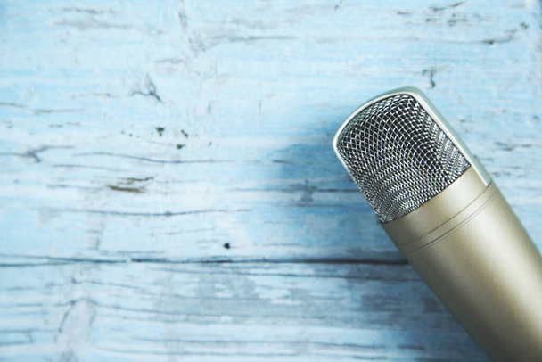 microphone on the  blue wooden table background - 写真・画像