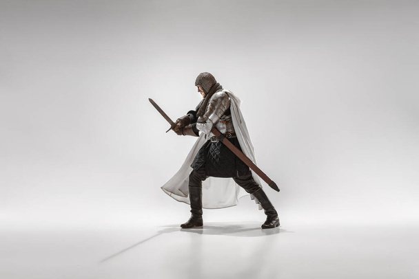 Brave armored knight fighting isolated on white studio background - Zdjęcie, obraz