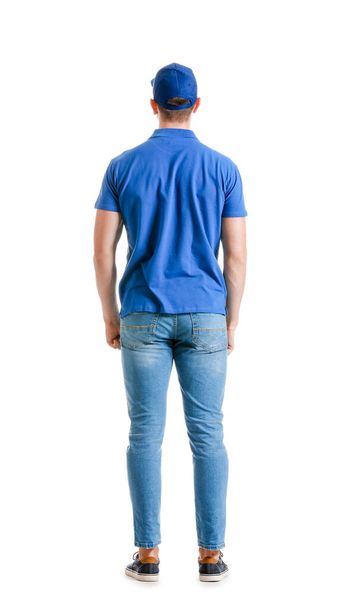 Handsome delivery man on white background, back view - Foto, imagen