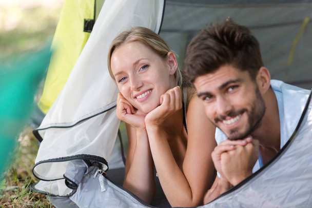 man and woman inside camping tent - Foto, Bild