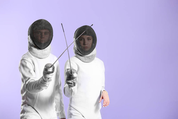 Young fencers on color background - Photo, Image