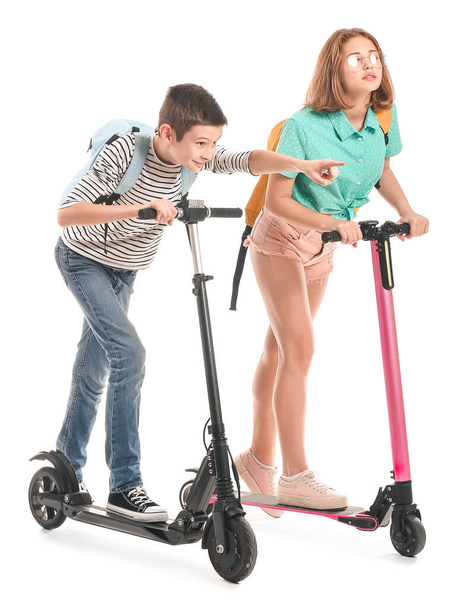 Active teenagers riding kick scooters on white background - Foto, Imagem