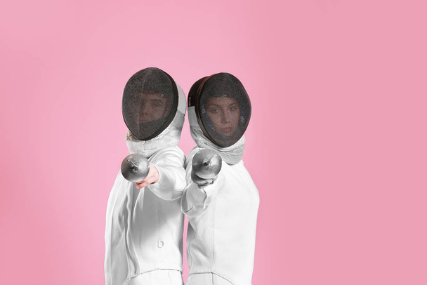 Young fencers on color background - Photo, Image