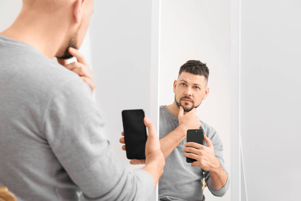 Man taking selfie in front of mirror at home - Photo, Image