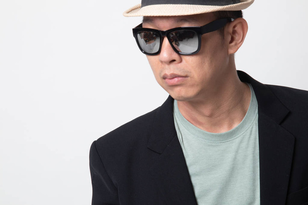 Portrait of an adult asian man  in sunglasses on white background - Fotó, kép