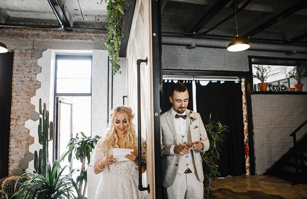 the bride and groom cry with happiness on their wedding day after reading letters - Фото, зображення