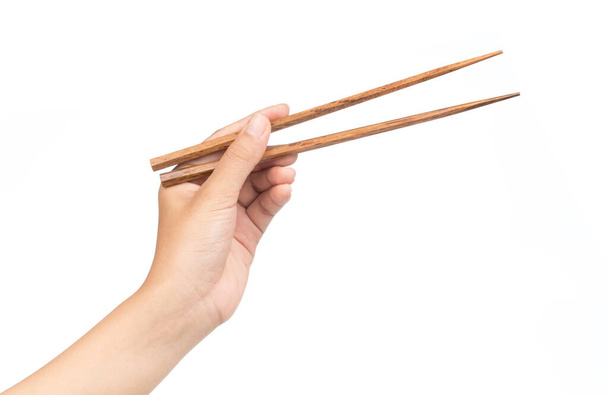 hand holding Wooden chopsticks isolated on white background - Valokuva, kuva